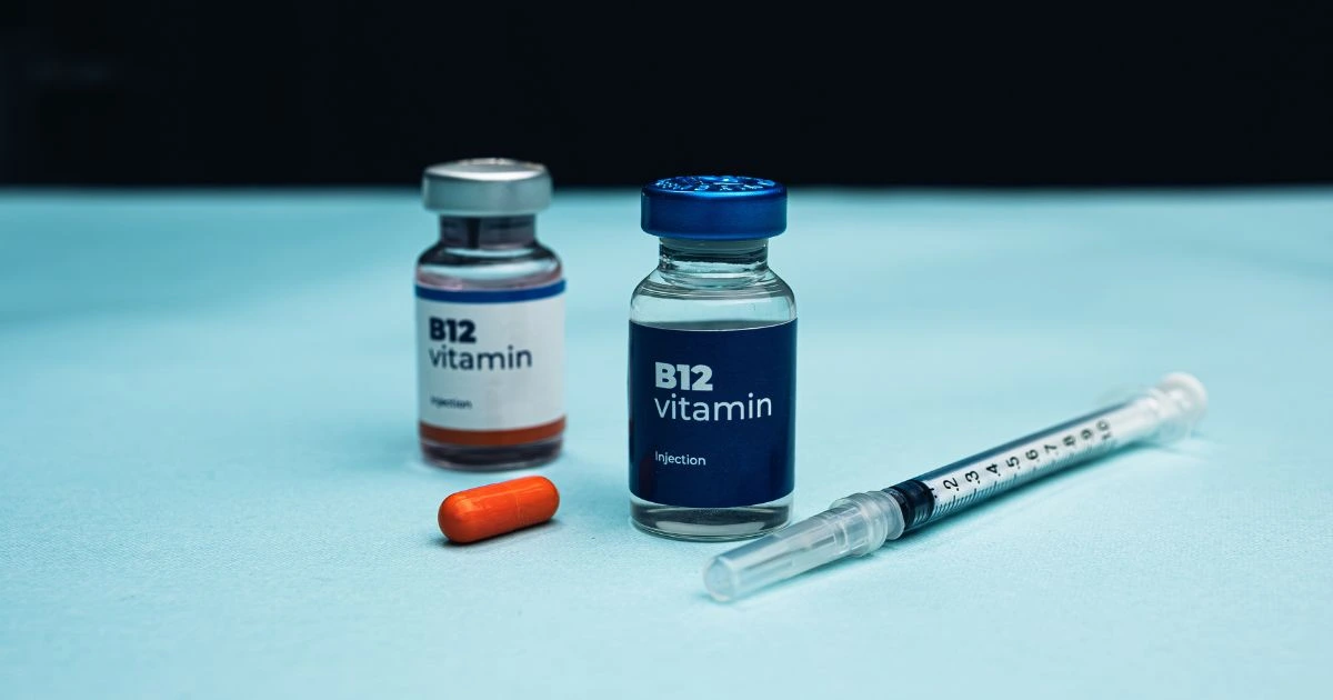 Close-up of a vial of liquid vitamin injections being prepared for an immune-boosting injection.